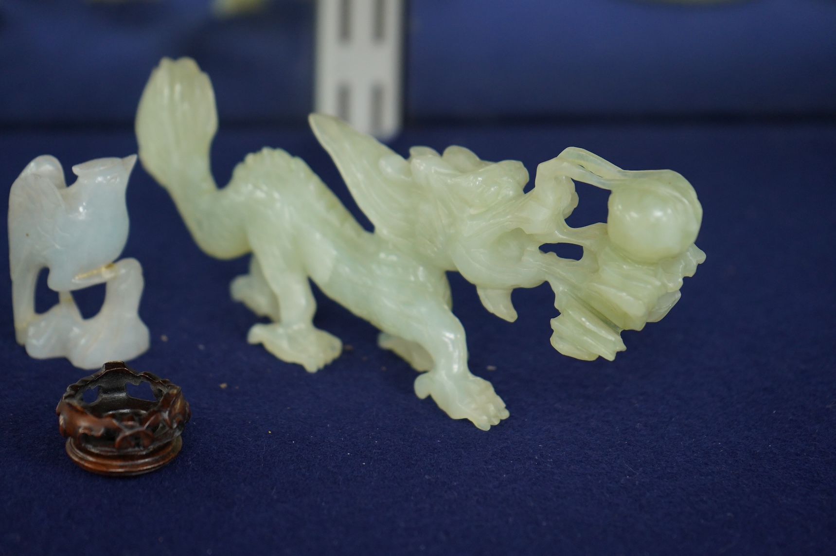 A Chinese jade figure of a Mandarin duck and a miniature pot and cover, three jadeite carvings and a bowenite dragon, 16.5cm